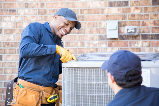 Homeowner in Coral Springs standing next to an air conditioner, serviced by a local HVAC contractor, enjoying a warm day outdoors.