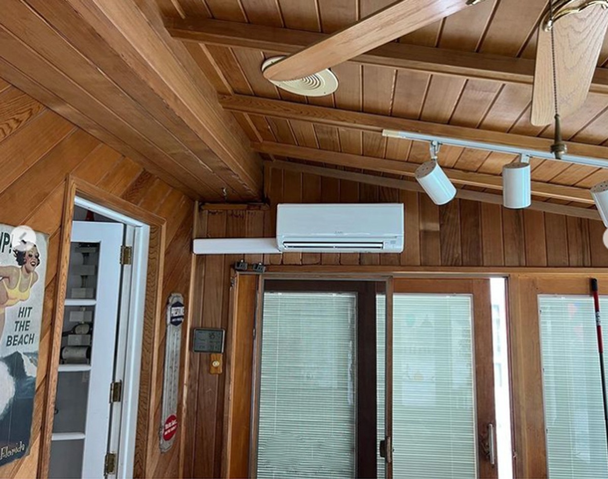 Air conditioning unit technician checking components indoors