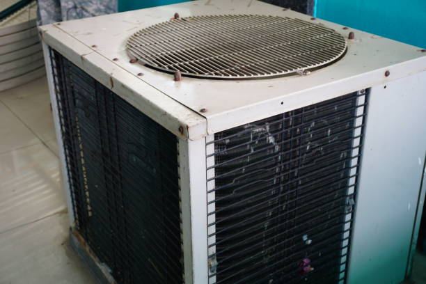  A heat pump, labeled as a 3-ton AC unit, located in front of a house, demonstrating its outdoor installation.