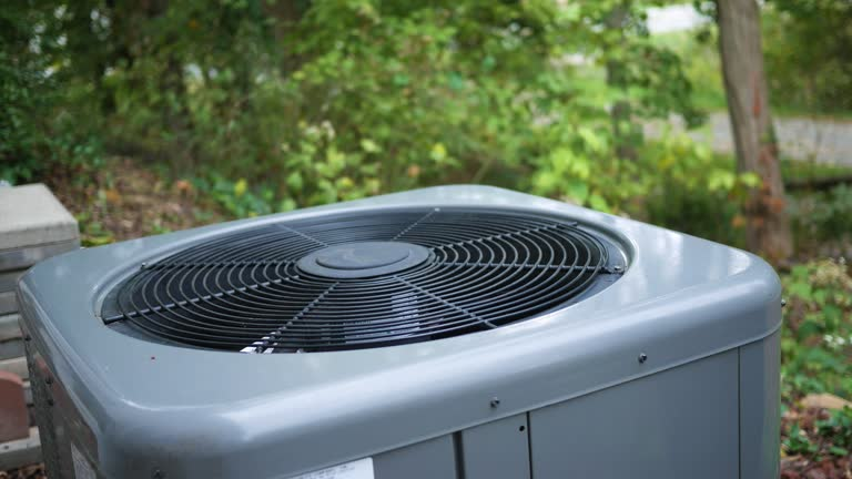  A 3-ton heat pump installed in front of a residential house, showcasing its outdoor unit and surrounding landscaping.
