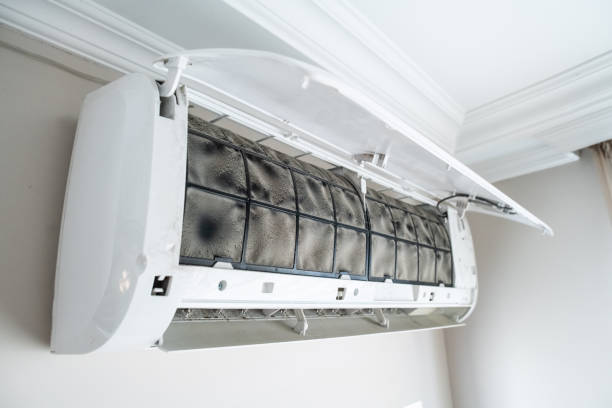 A operater open AC cover to operate an air conditioner, addressing the problem of warm air in Margate, FL